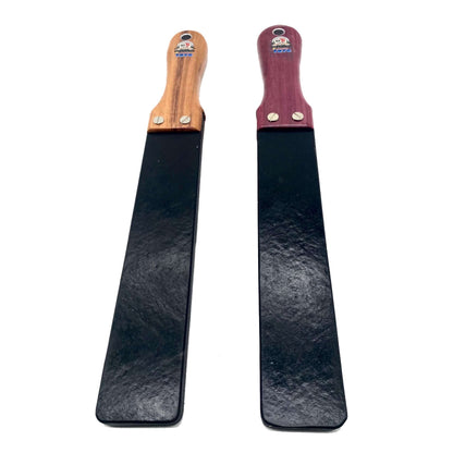 Master Control's Woodshop & Toys's Rubber Barber Strap - 1/2” Medium - This is a Handmade upon order product. The product usually takes 7-10 days to create. This 1/2" Rubber Barber Strap Spanking Paddle never fails to get an "ouch" of appreciation! Availa